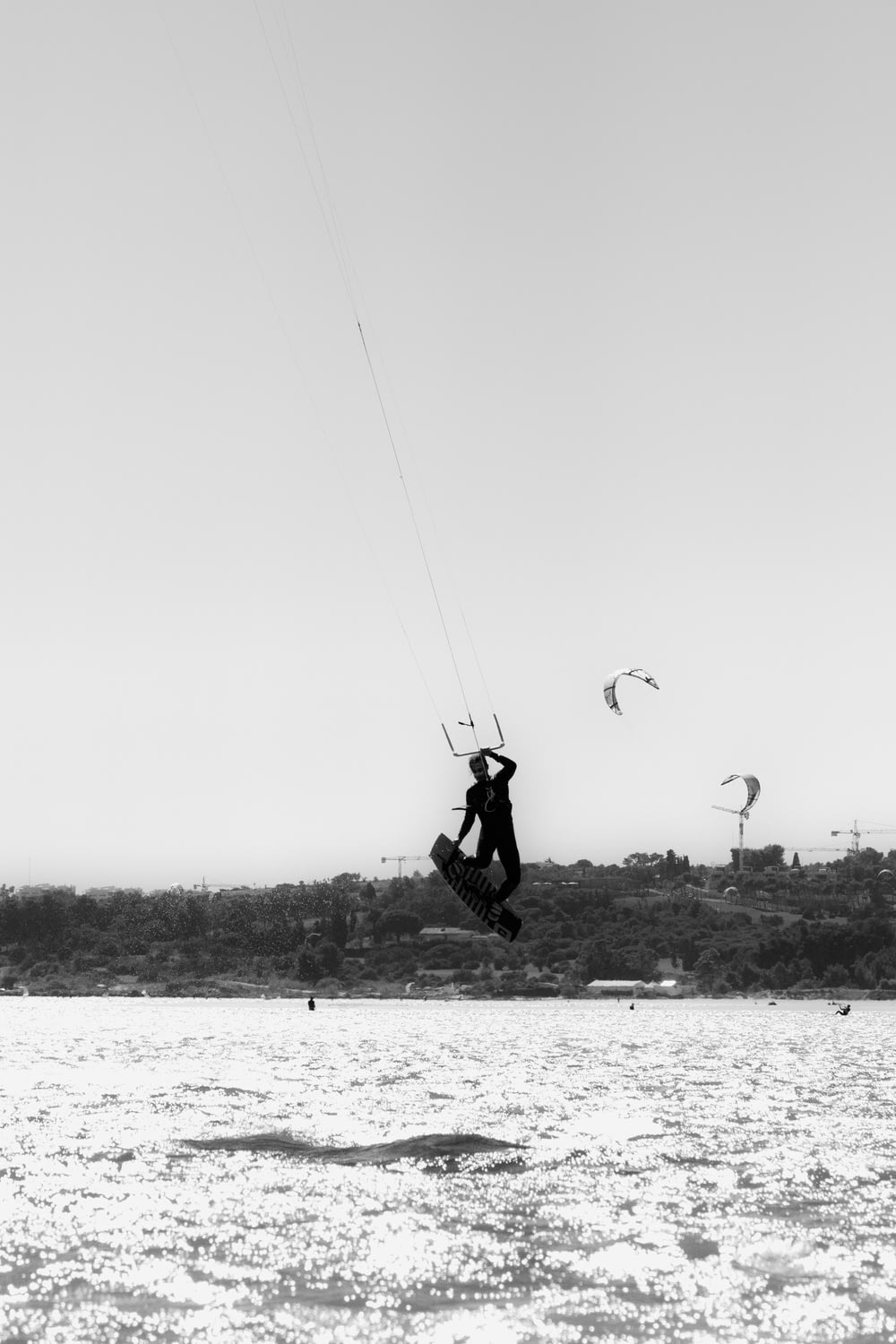 person in parachute in grayscale photography
