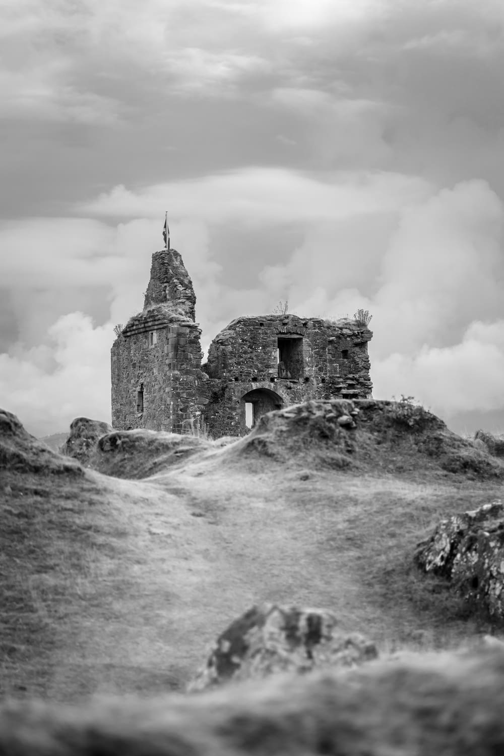grayscale photo of castle on hill