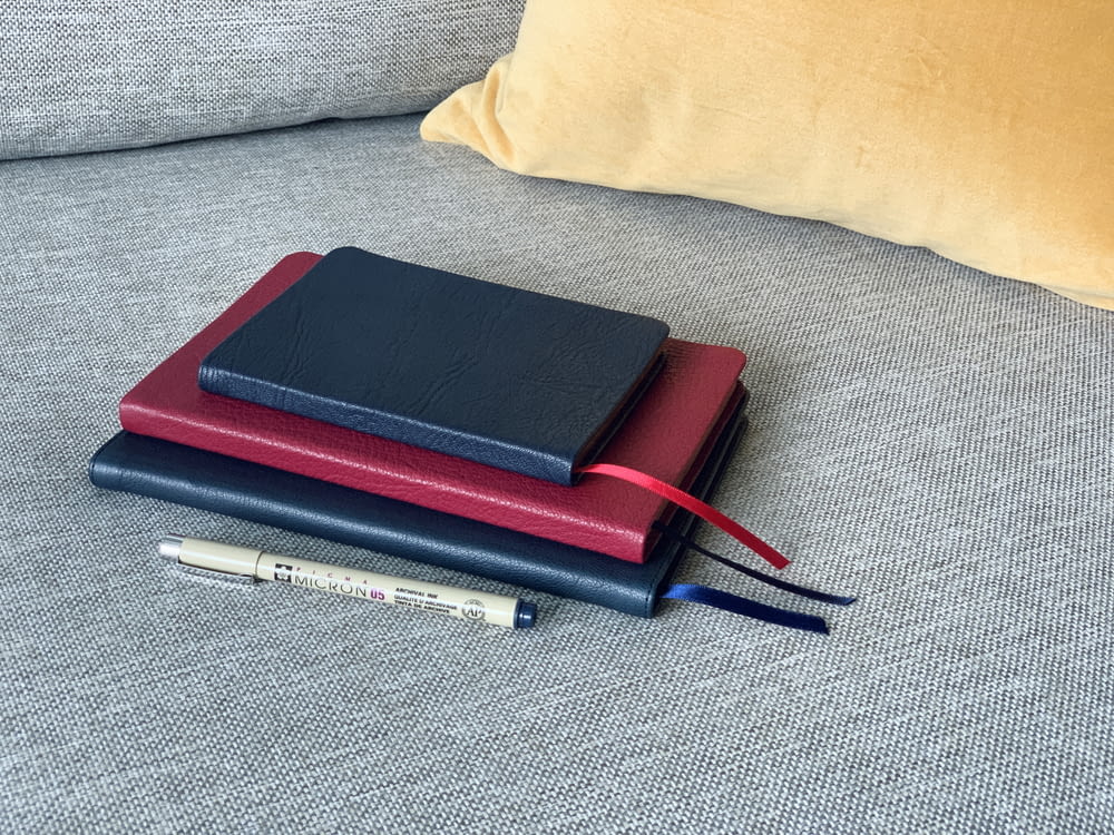 red and black tablet computer case on gray textile