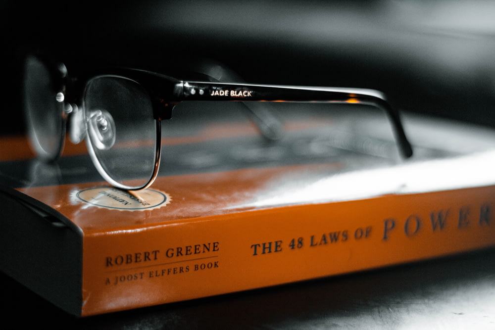 black framed eyeglasses on book