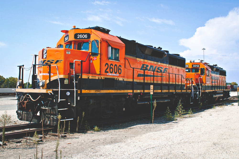 orange train on rail tracks during daytime