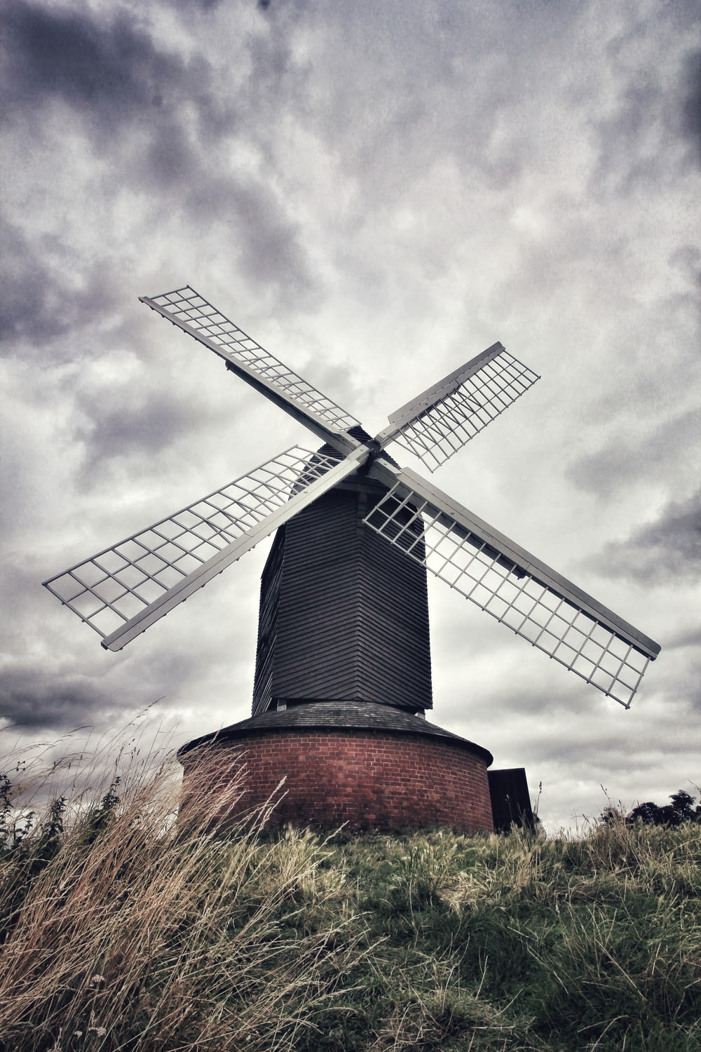 brown and gray windmill under cloudy sky during daytime