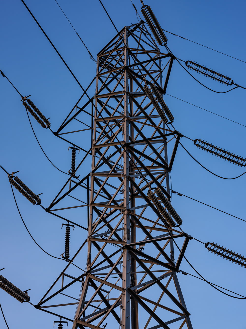 black electric towers under blue sky during daytime