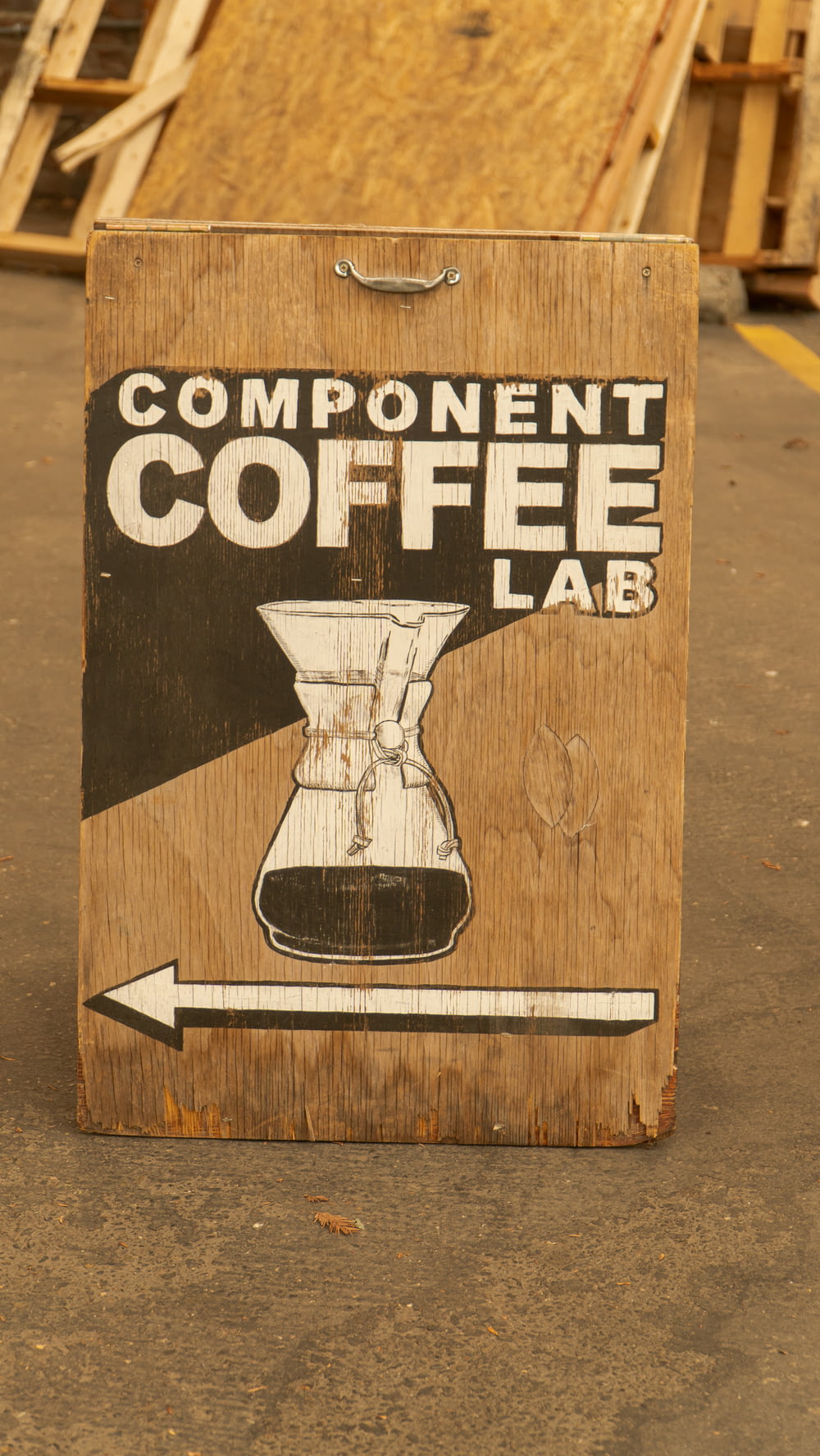 a wooden sign advertising a coffee lab