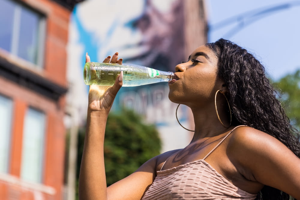 woman drinking water from bottle