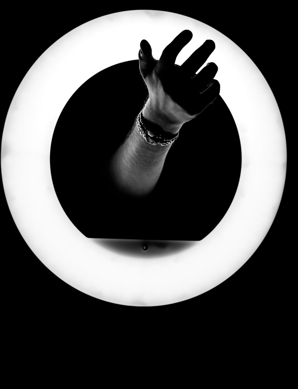 grayscale photo of person holding round frame