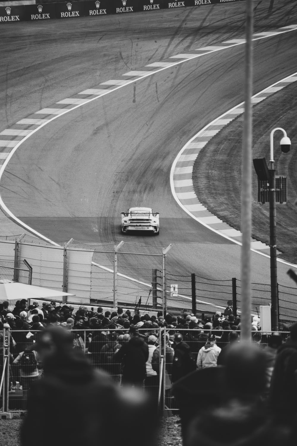 grayscale photo of people on race track