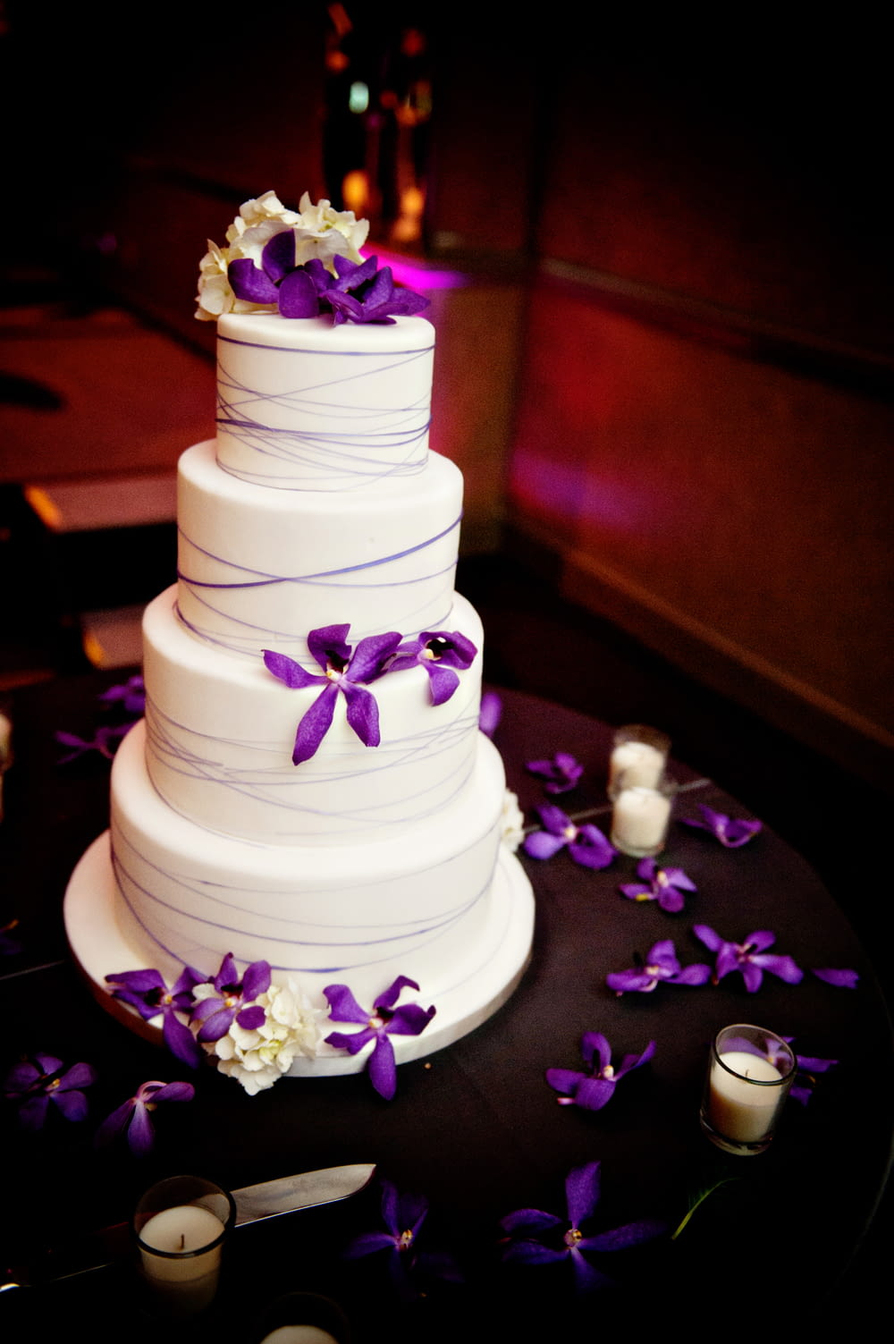 white 3 tier cake with purple flowers