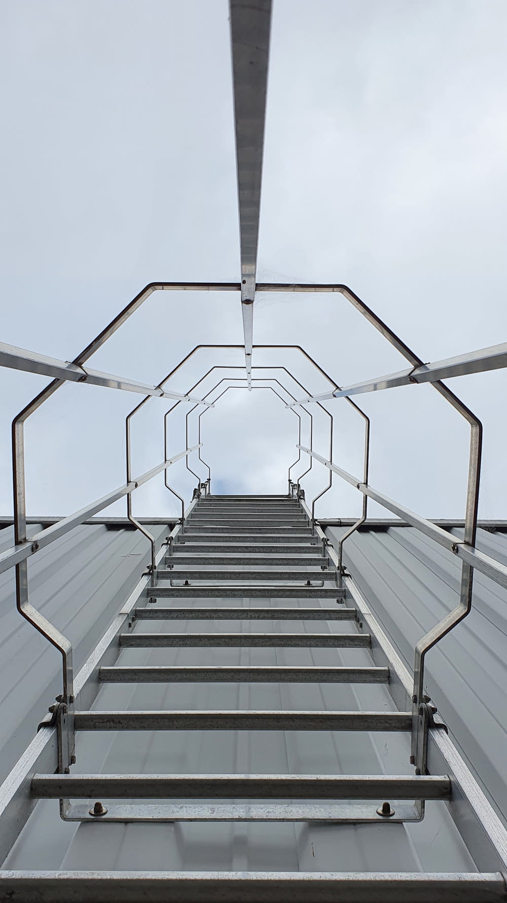 low angle photography of gray metal ladder