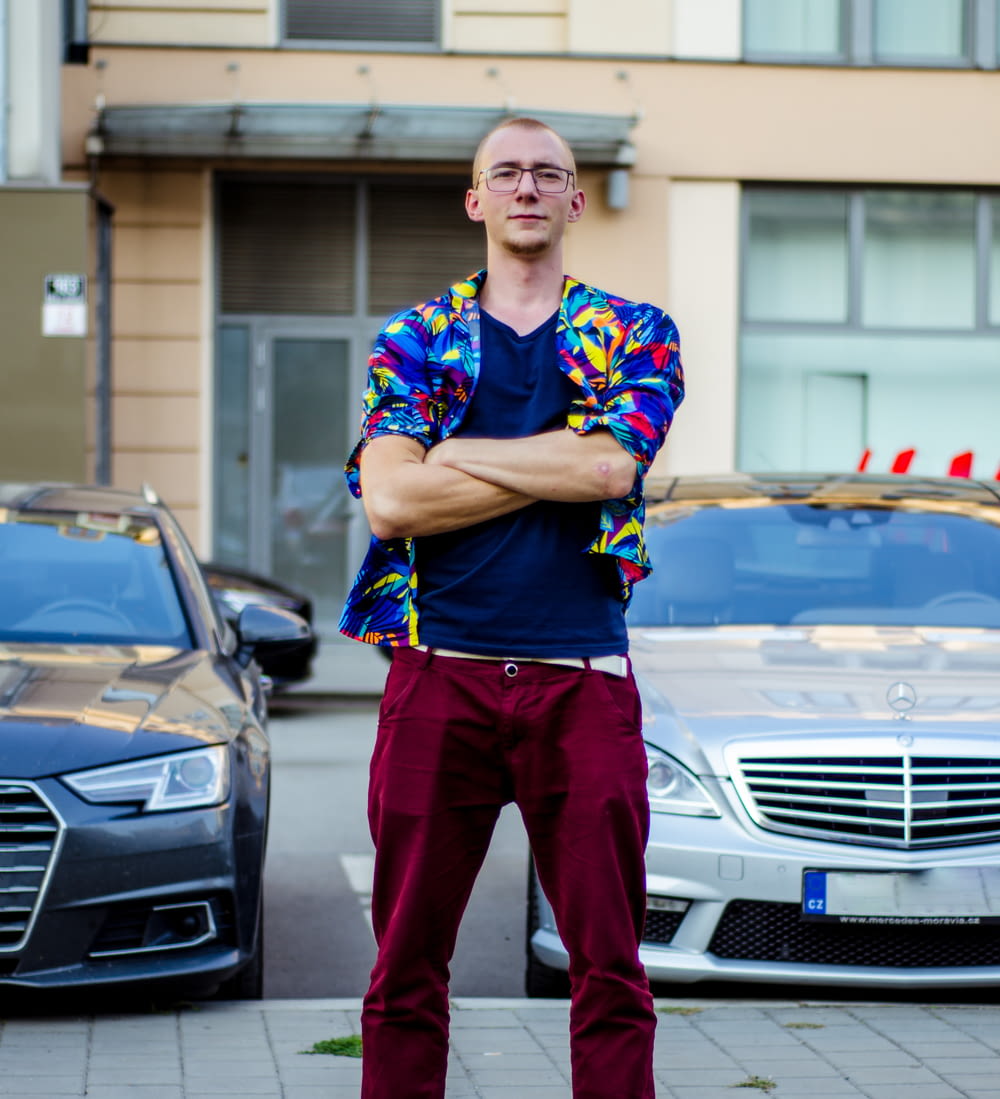 a man standing in front of some parked cars
