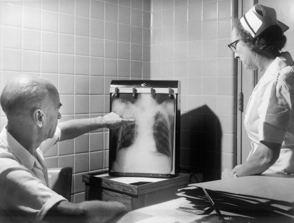 a man and a woman looking at a chest x - ray