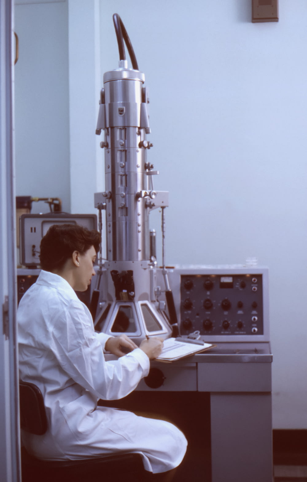 a man sitting at a desk in a lab