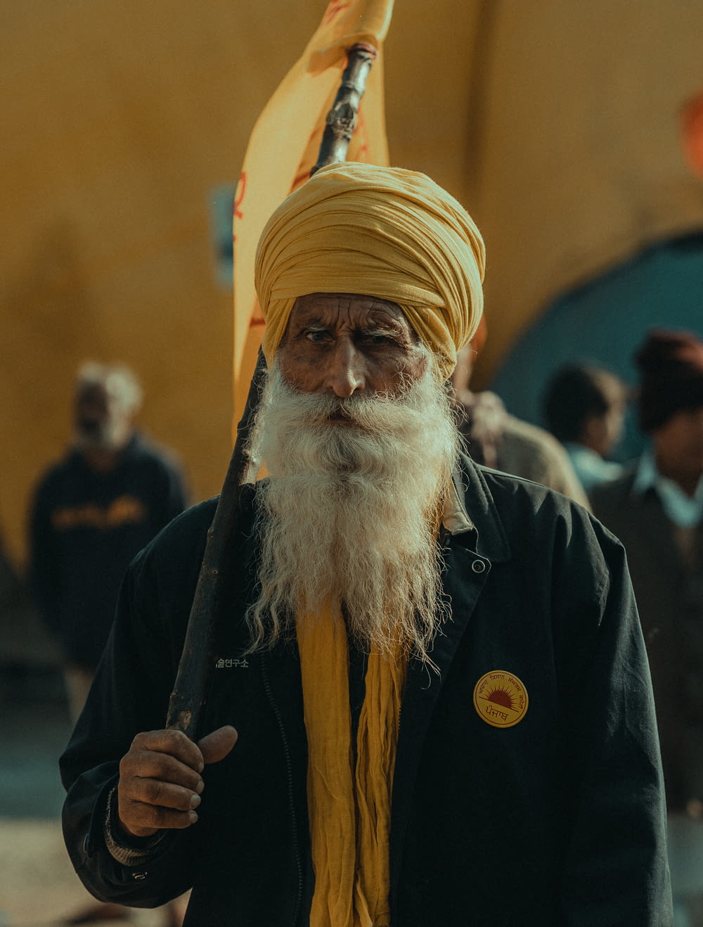 a man with a long white beard and a yellow turban
