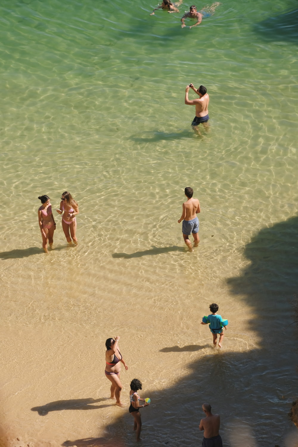 a group of people in the water at a beach