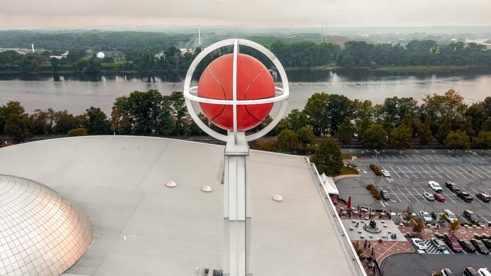 a large red ball on top of a building