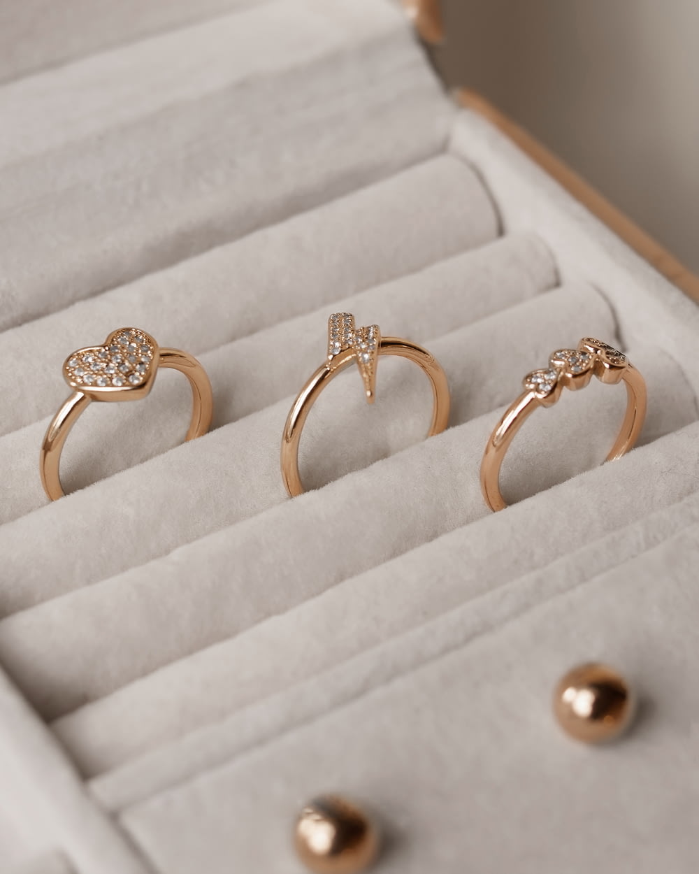 three gold rings in a white box