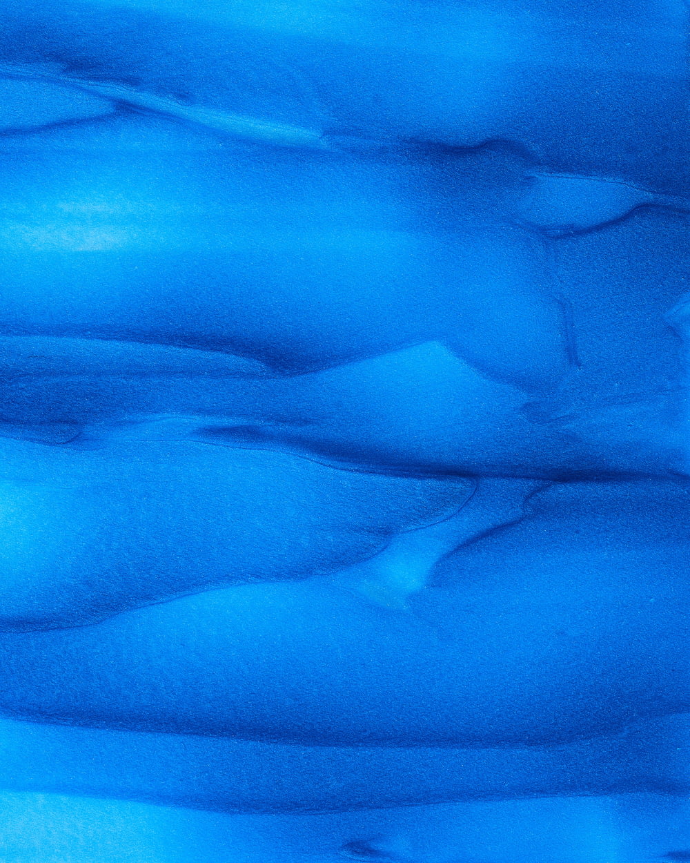 a close up of a blue substance in the water
