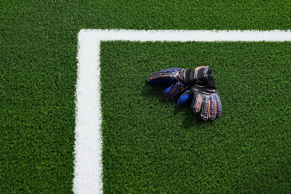 a soccer goalie's glove laying on a soccer field