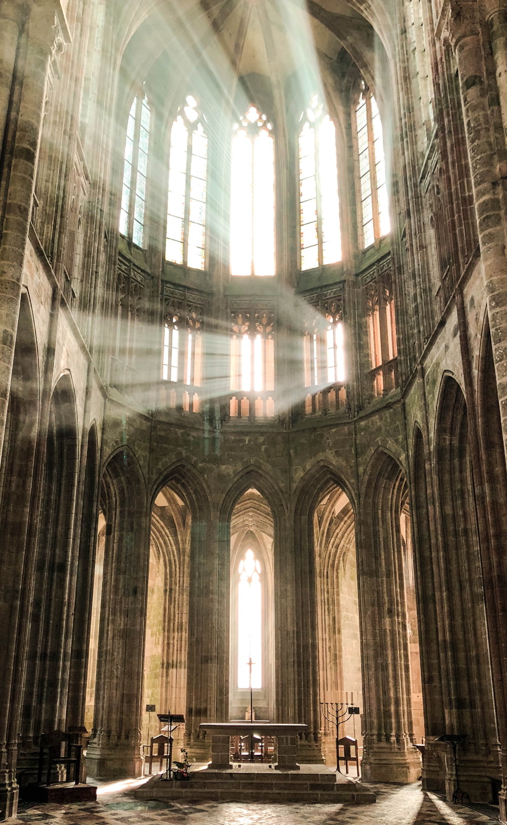 sunlight streams through the windows of a cathedral