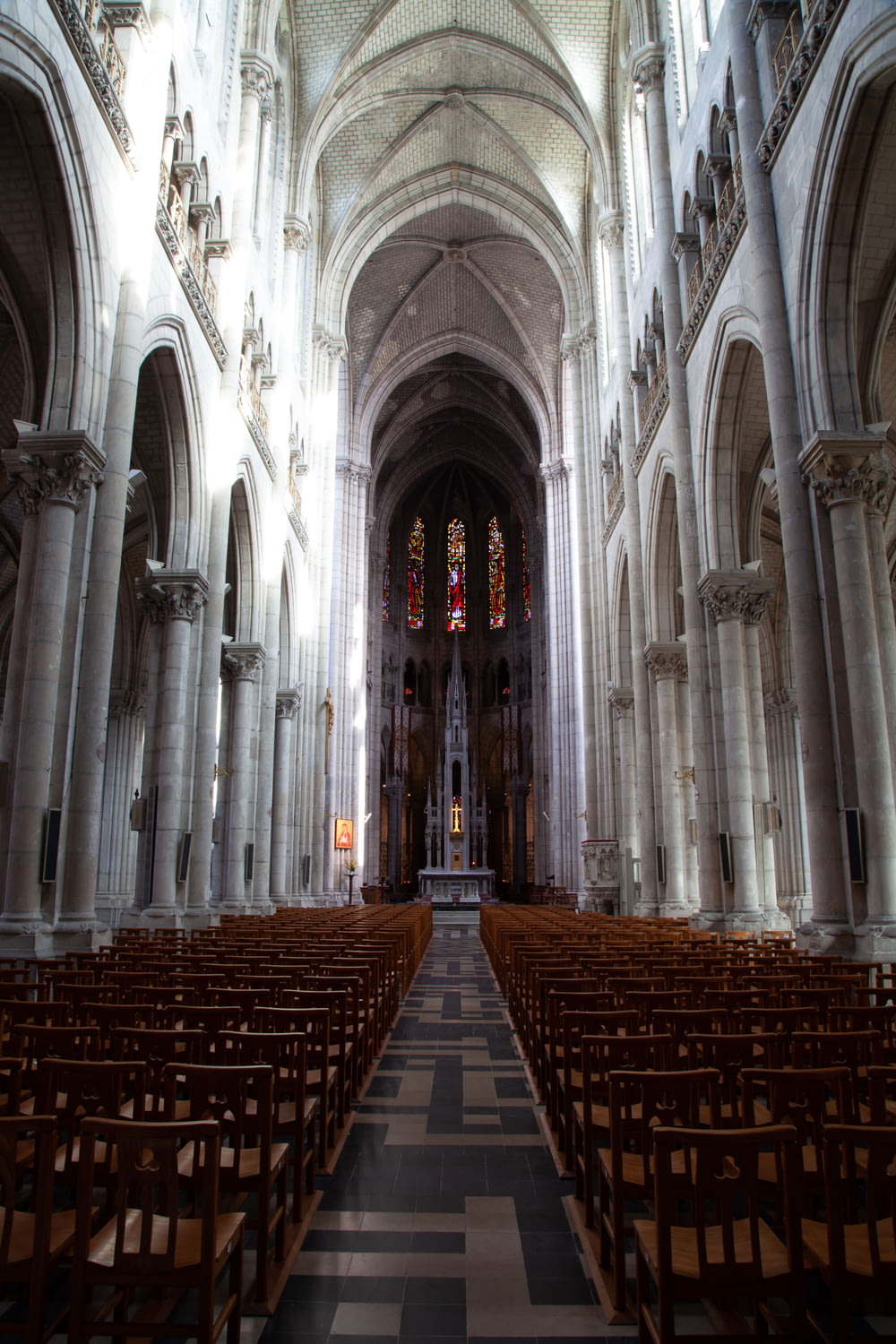 a large cathedral with pews and stained glass windows