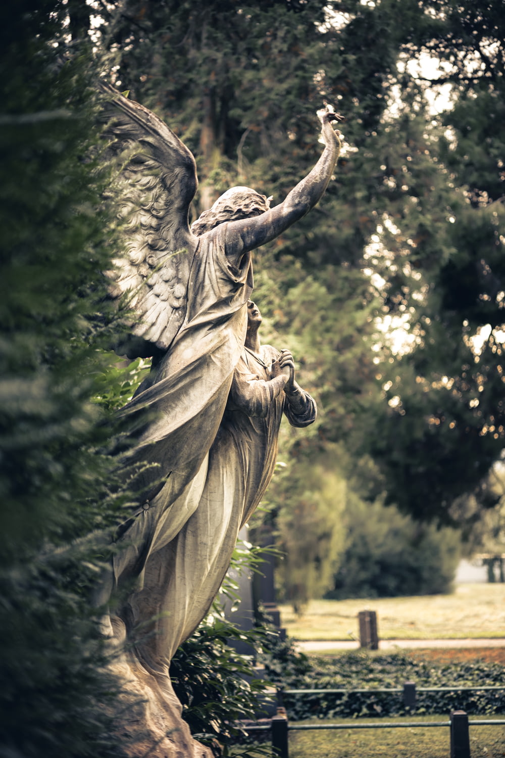a statue of an angel in a park