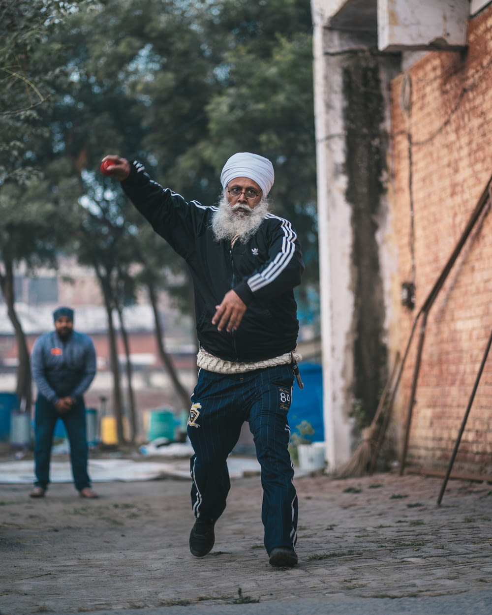 a man in a turban throws a frisbee