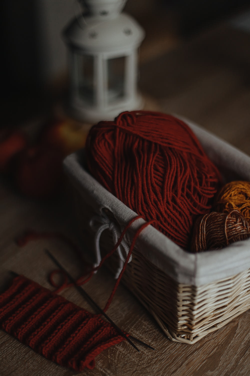 a basket of yarn and a pair of scissors on a table