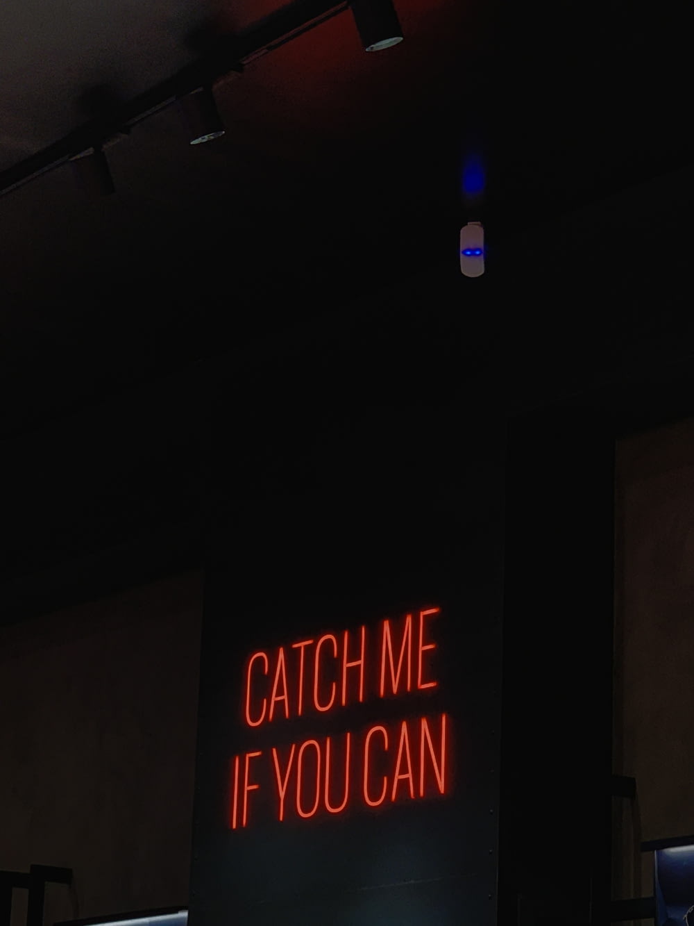 a neon sign that reads catch me if you can