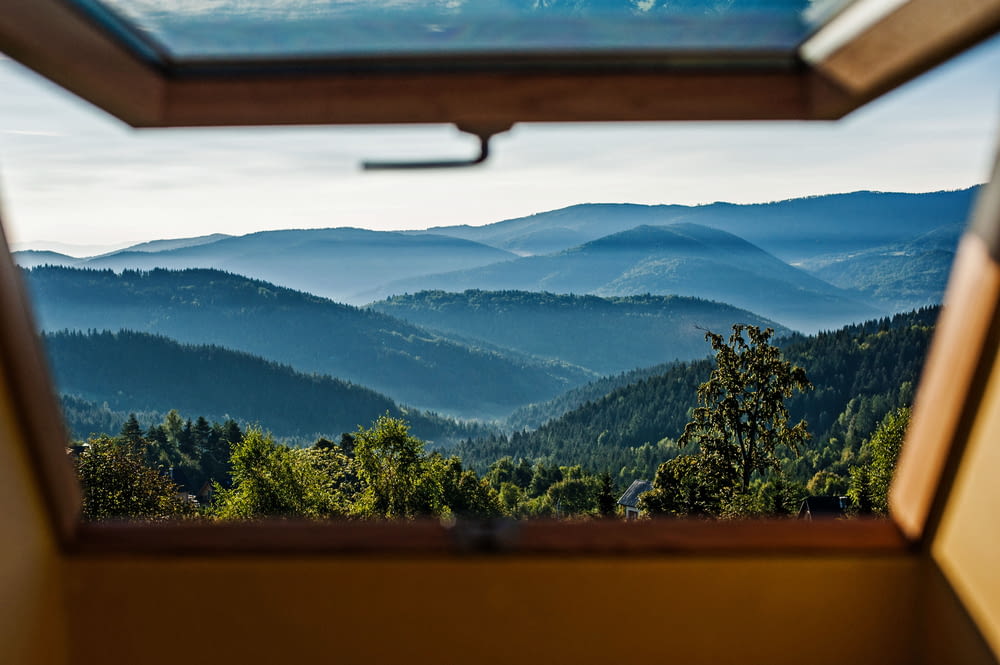 a view of a mountain range from a window