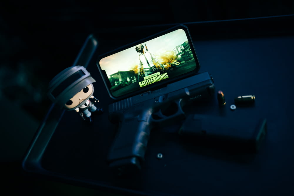 a toy gun and a cell phone sitting on a table
