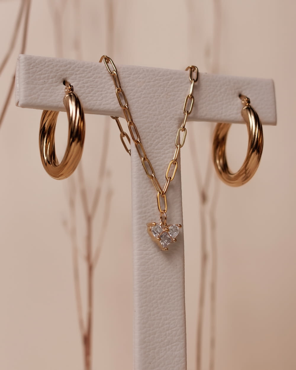 a close up of a pair of earrings on a stand