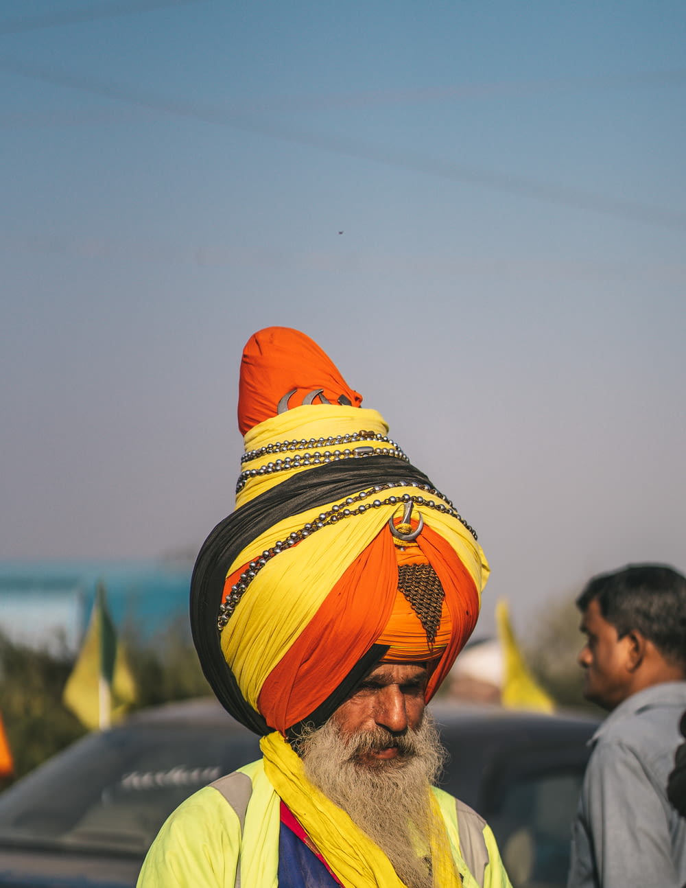 a man wearing a turban and a yellow scarf