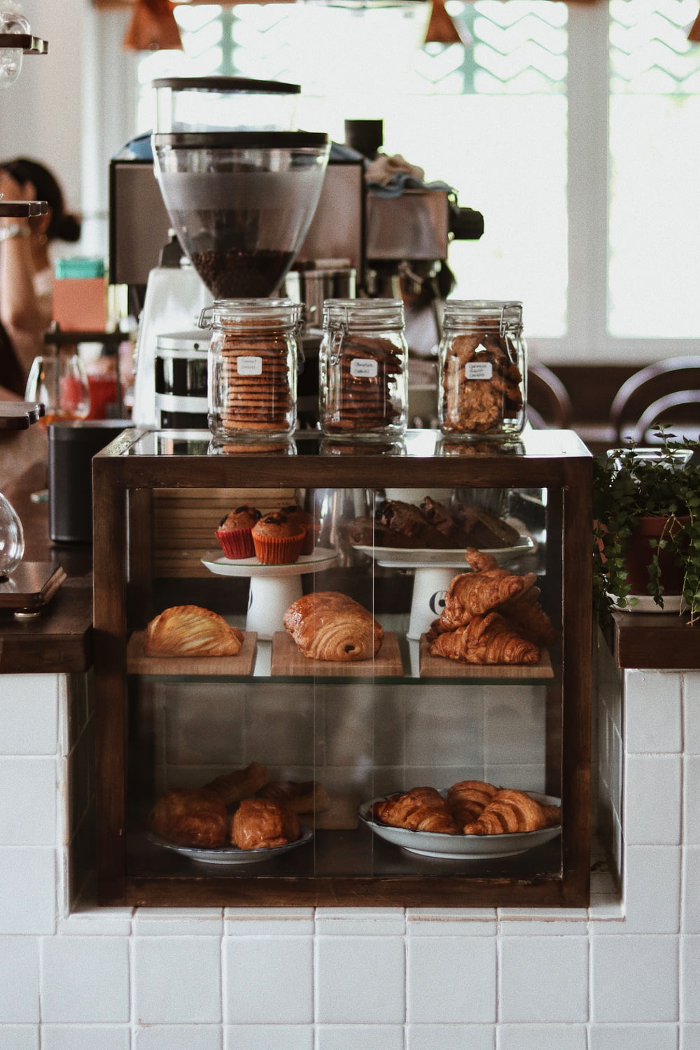 a bakery counter with pastries and coffee machines