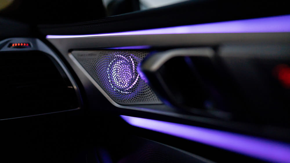 a close up of a car dashboard with a blue light