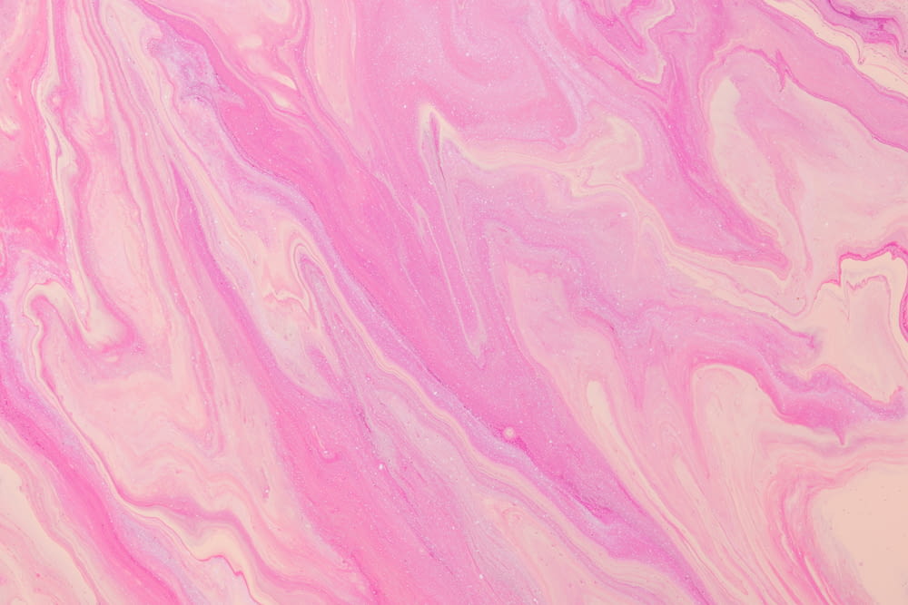 a close up of a pink and white marble