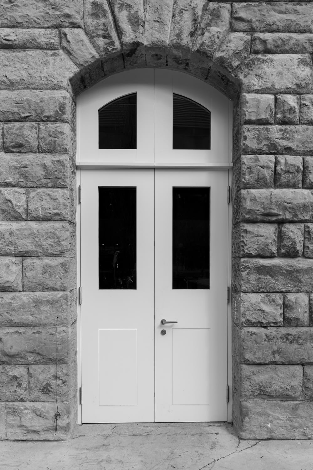 a black and white photo of a double door