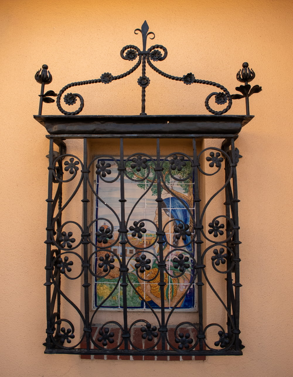 a picture of a painting on a wall behind a wrought iron window