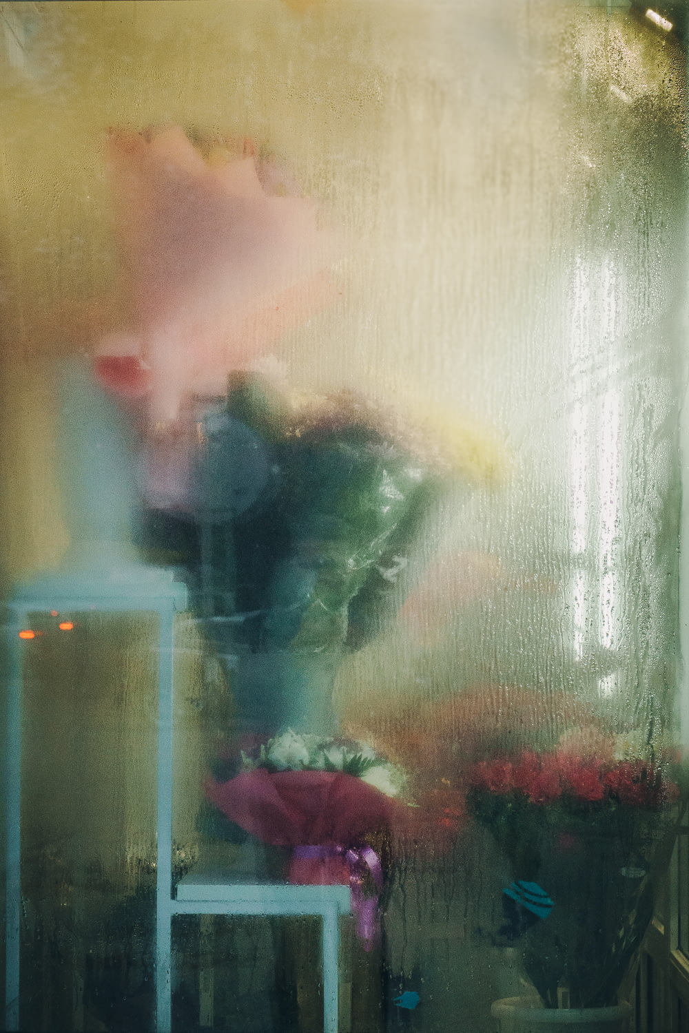 a vase of flowers sitting on a table next to a window
