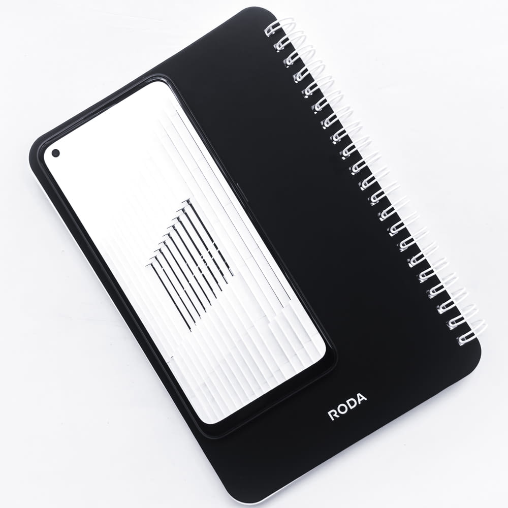 a spiral notebook with a black cover and white lines