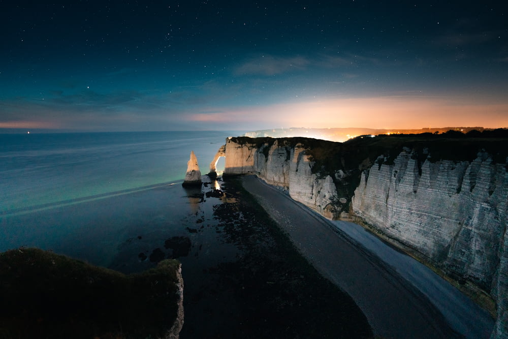 a view of the ocean and cliffs at night