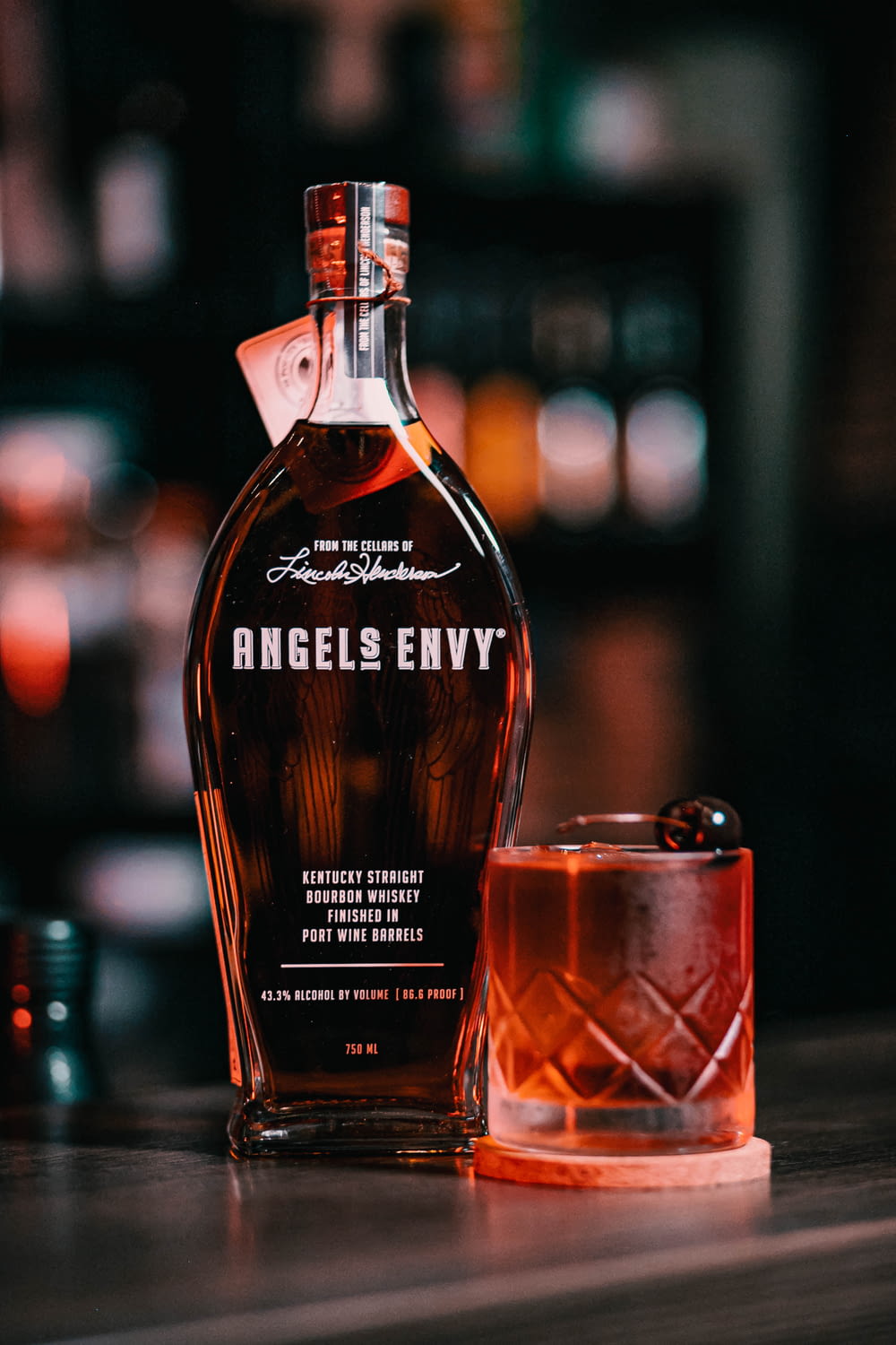 a bottle of angel's envy next to a shot glass