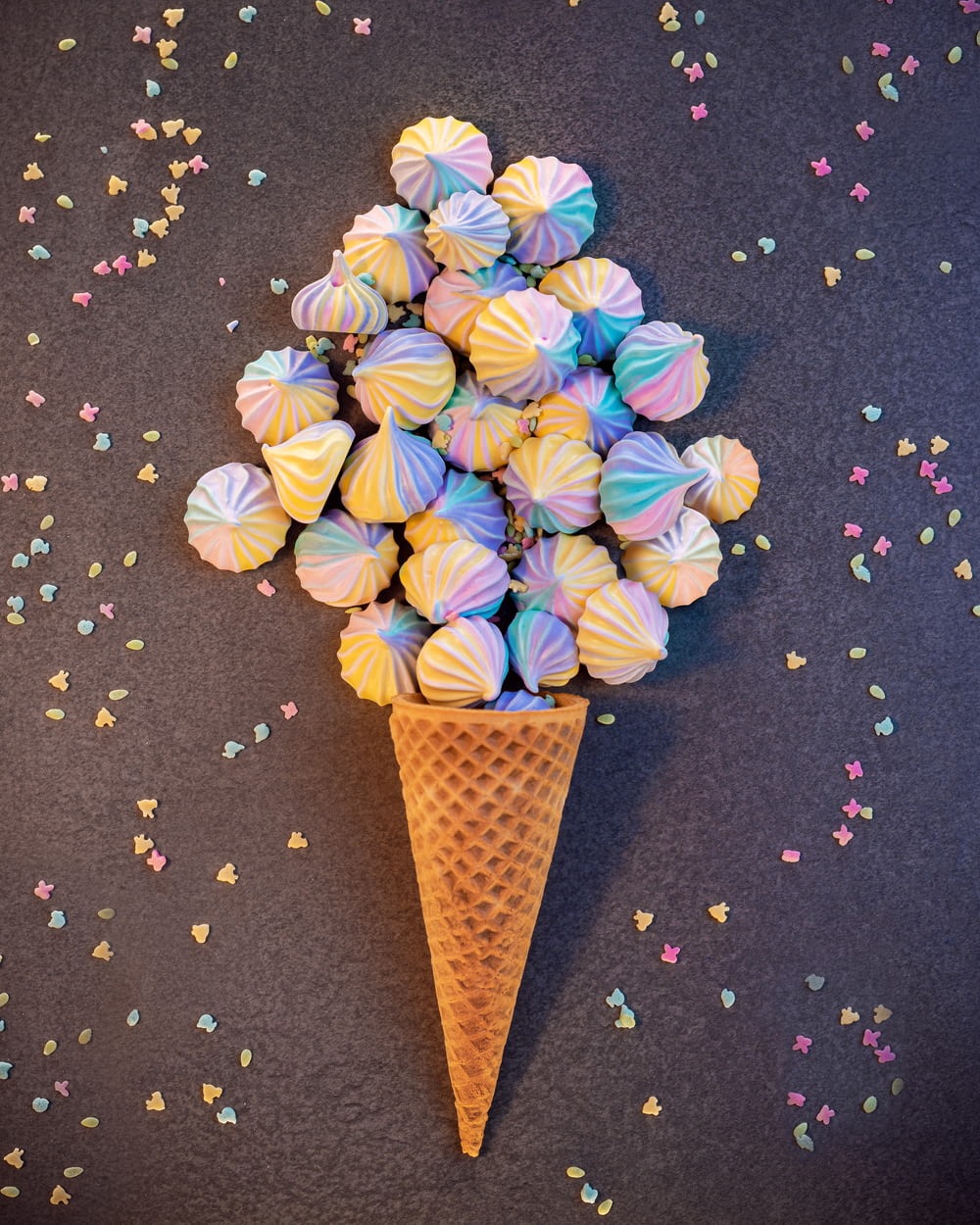 a cone filled with colorful candies on top of a table