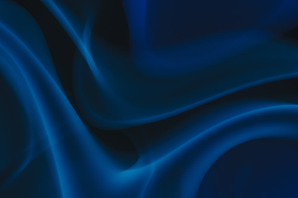 a blue and black background with wavy lines