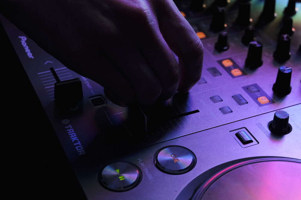 a dj mixing a track in front of a mixer