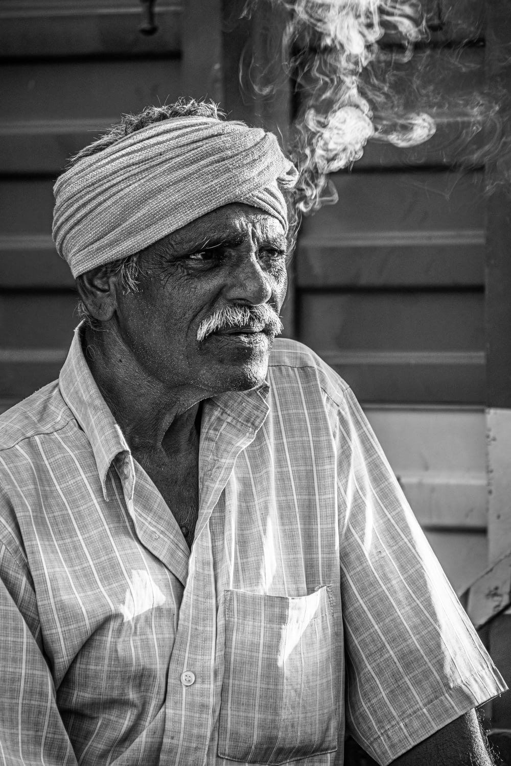 a man with a turban smoking a cigarette