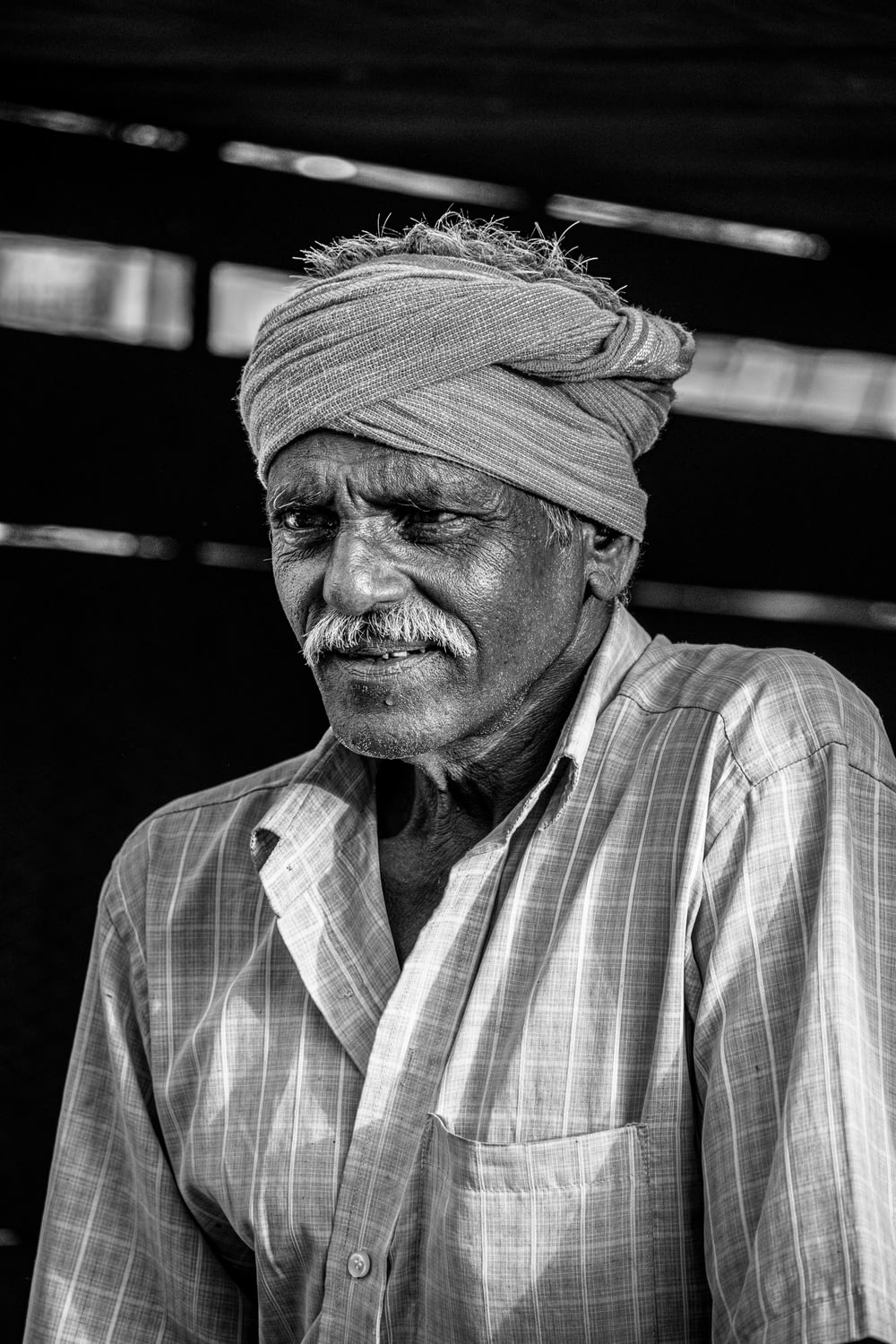 a black and white photo of a man wearing a turban