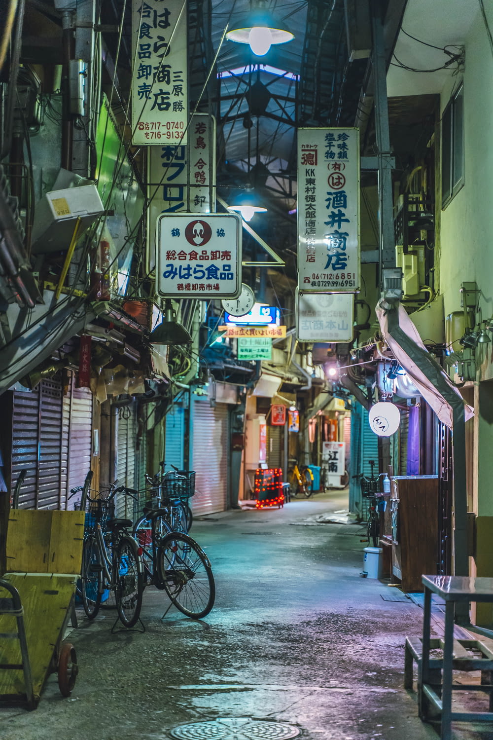 a narrow alley way with many signs hanging from the ceiling
