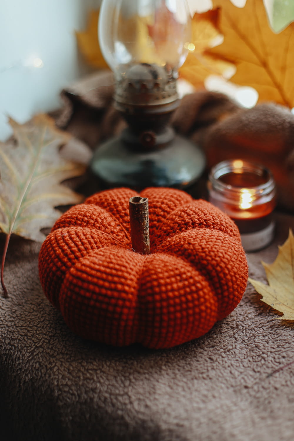 an orange knitted pumpkin sitting on a table
