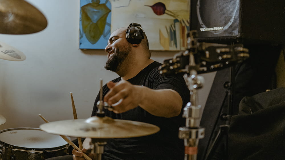 a man with headphones on playing drums