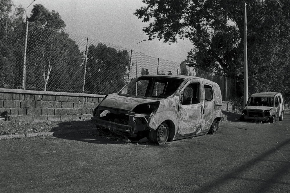 a black and white photo of a broken down van